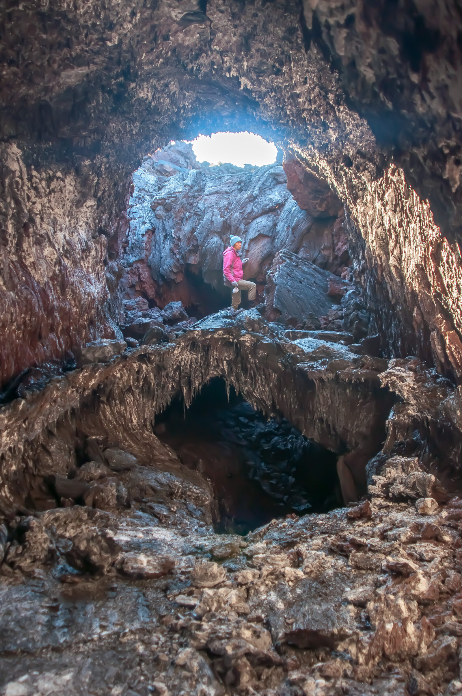 A female volcanologist in a lava cave during the 2012-13 Tolbachik Fissure Eruption.